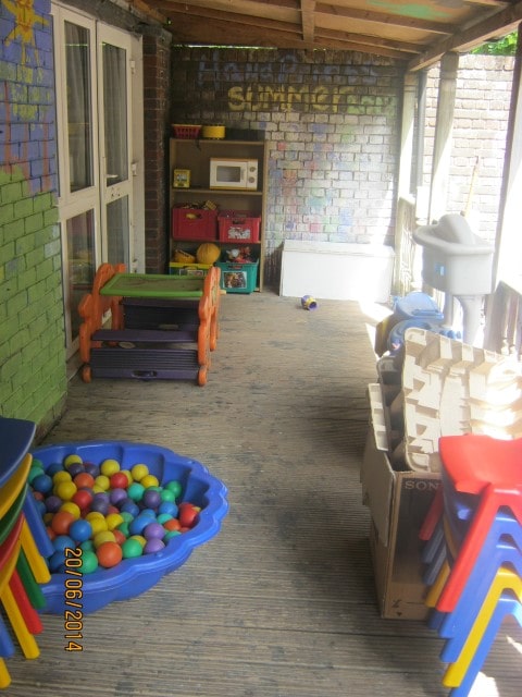 Our delightful covered, boarded outside play area